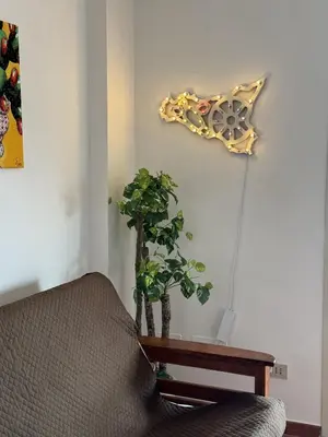 a plant sitting on a table next to a couch at Luna Marina - Sicilian beach house in Santa Flavia
