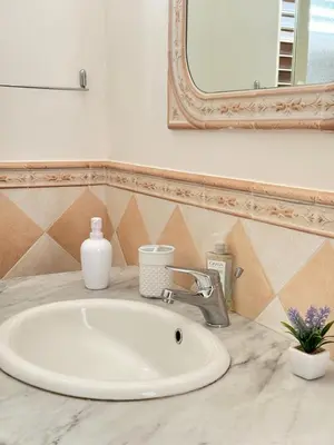a bathroom with a sink and a mirror at Luna Marina - Sicilian beach house in Santa Flavia