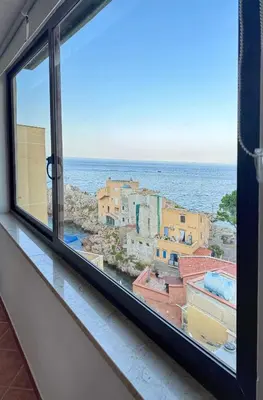 a window with a view of the ocean at Luna Marina - Sicilian beach house in Santa Flavia