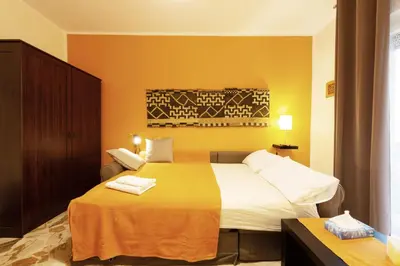 a hotel room with a bed with two towels on it at La Favorita - Ben collegato con l'aeroporto, la spiaggia di Mondello e il centro città in Palermo