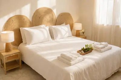 a bedroom with a white bed with a large wooden headboard at Oltremare Suite N37 Benessere invernale con vista mare in Bagheria