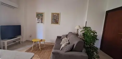 a living room with a couch and a tv at Casa di Nat in Palermo