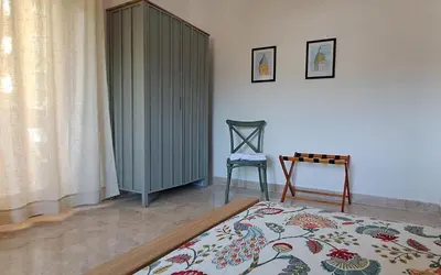a living room with a green cabinet and a rug at Casa di Nat in Palermo