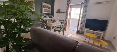 a living room with a couch and a dining room at Casa di Nat in Palermo