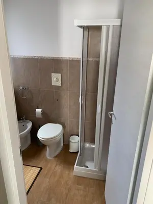 a small bathroom with a toilet and a shower at CentruMassimo Apartment in Palermo