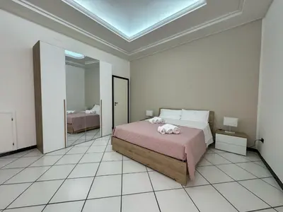 a room with a mirror and a table and a bed at Angolo Lamia Sicily Apartment in Partinico