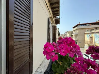 a kitchen with white cabinets and a stove top oven at Angolo Lamia Sicily Apartment in Partinico