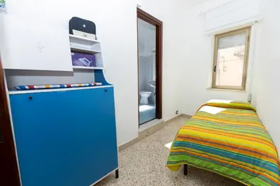 a room with a blue cabinet and a bed at STELLA BLU in Calatafimi