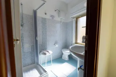 a bathroom with a shower and a toilet and a sink at STELLA BLU in Calatafimi