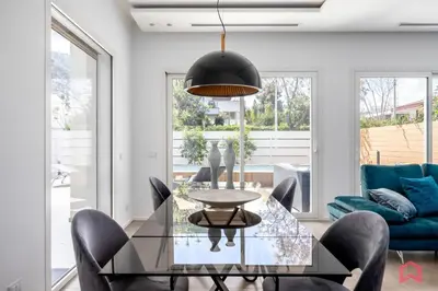 a dining room with a glass table and chairs at Appartamento in villa con piscina privata in Palermo
