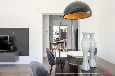 a dining room with a glass table and chairs at Appartamento in villa con piscina privata in Palermo