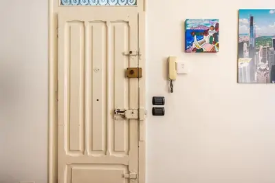 a white door with a phone next to a wall at [MoroHouse] 50mt from Teatro Massimo in Palermo