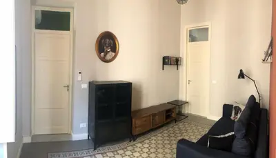 a living room with a couch and a television at Appartamento Vento D'Estate in Bagheria