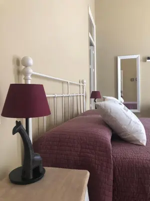 a bedroom with a bed with a lamp on a table at Appartamento Vento D'Estate in Bagheria