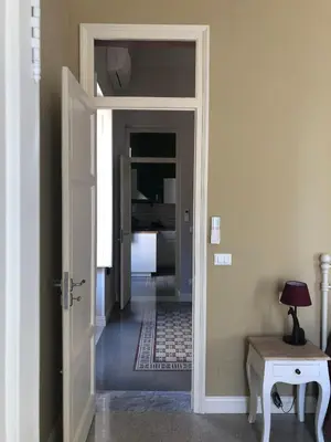 a hallway with a door leading into a room at Appartamento Vento D'Estate in Bagheria