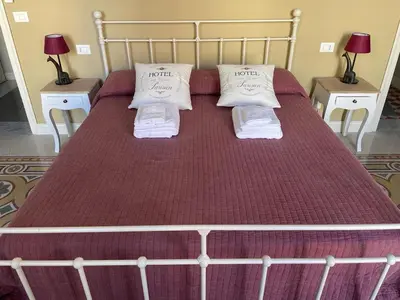 a large bed with two pillows on top of it at Appartamento Vento D'Estate in Bagheria