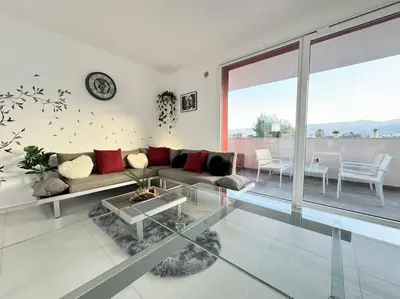 a living room with a couch and a glass table at Attico Magnificent [Wi-Fi/Free Parking] in Palermo