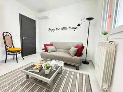 a living room with a couch and a coffee table at Attico Magnificent [Wi-Fi/Free Parking] in Palermo