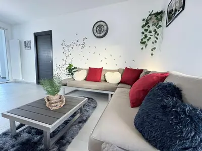 a living room with a couch and a table at Attico Magnificent [Wi-Fi/Free Parking] in Palermo