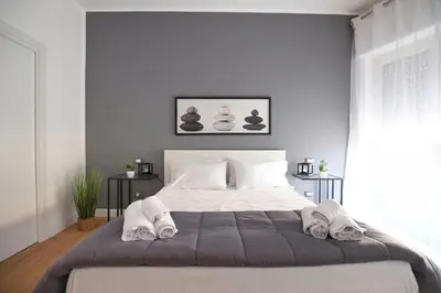 a bedroom with a large bed with towels on it at iFlat Normanni Lounge Apartment in Palermo