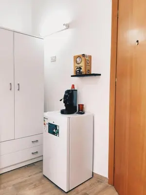a kitchen with a white refrigerator and a microwave at Monteleone rooms in Palermo