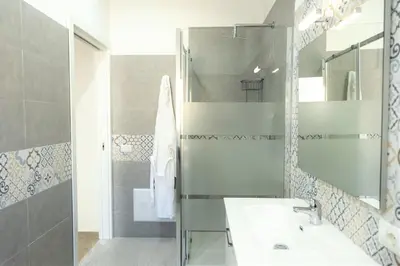 a bathroom with a sink and a shower at Casa Vacanze Altea in Santa Flavia