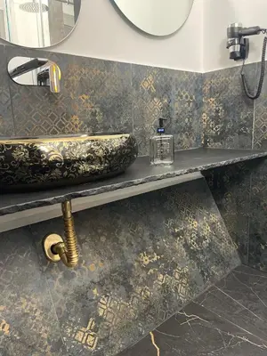 a bathroom with a sink and a mirror at Casa Vacanze Donna MariaCarme' in Palermo
