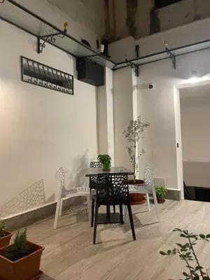 a table and chairs in a room with plants at Casa Vacanze Donna MariaCarme' in Palermo