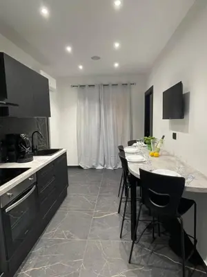 a kitchen with a table and some chairs in it at Casa Vacanze Donna MariaCarme' in Palermo
