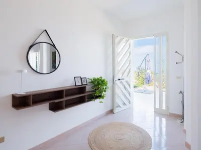a white hallway with a mirror and a sink at Villa Moon Total Relax in Alcamo