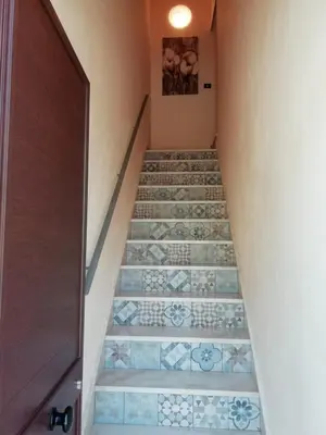 a staircase with blue and white tile floors at Vista sul mare e splendido terrazzo in Castellammare del Golfo