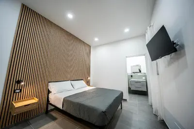 a bedroom with a bed with a wooden wall at Luna Marie in Palermo