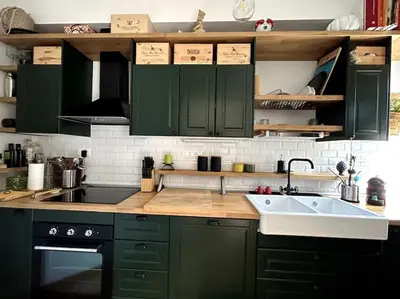 a kitchen with green cabinets and a sink at Casa sul Mare alle porte di Palermo in Isola delle Femmine