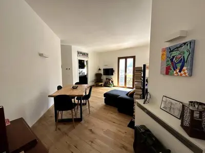 a living room with a table and a couch at Casa sul Mare alle porte di Palermo in Isola delle Femmine