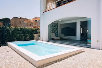 a swimming pool in the backyard of a house at Sant'Elia Luxury Home&Spa con accesso al mare in Santa Flavia