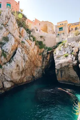 a cave in the side of a rocky cliff at Sant'Elia Luxury Home&Spa con accesso al mare in Santa Flavia