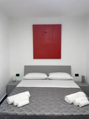 a bedroom with a large bed with two white pillows at Casa Vacanze Donna Sidora in Palermo