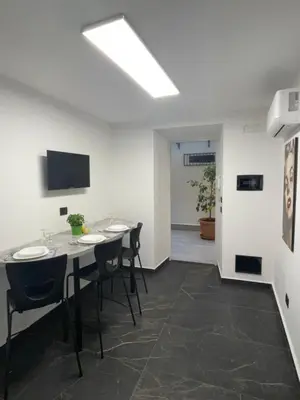 a meeting room with tables and chairs and a television at Casa Vacanze Donna Sidora in Palermo