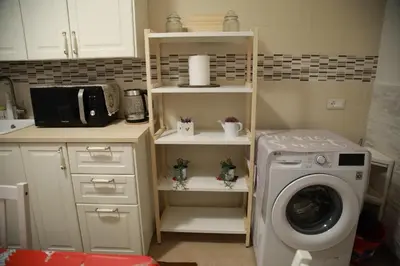 a kitchen with a washing machine in a kitchen at La Maison Du Centre in Palermo