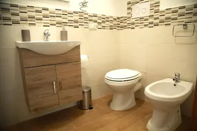 a bathroom with a sink and a toilet at La Maison Du Centre in Palermo