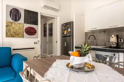 a kitchen with a table and chairs in a room at Villa Solià - Villa indipendente con Piscina e Giardino in Campofelice di Roccella