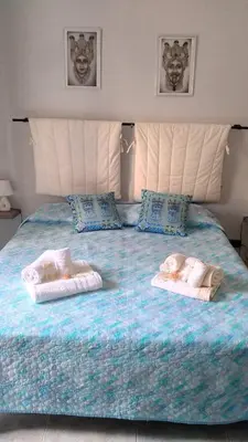 a large bed with two baby towels on it at Sikulamente in Palermo