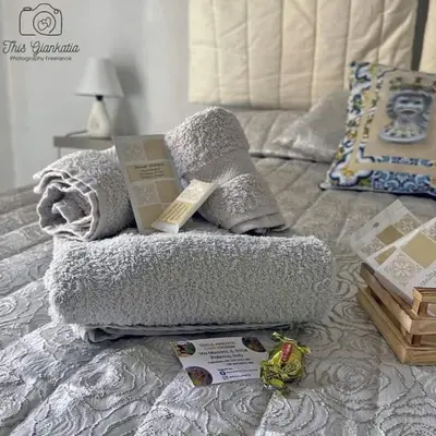 a bed with a pillow and a book on it at Sikulamente in Palermo