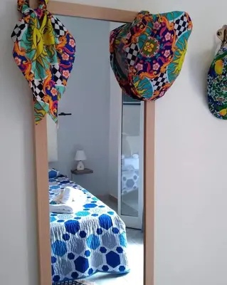 a mirror in a room with a bed and a mirror at Sikulamente in Palermo