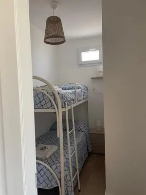 a room with two bunk beds and a lamp at Villa Vittoria in Trappeto