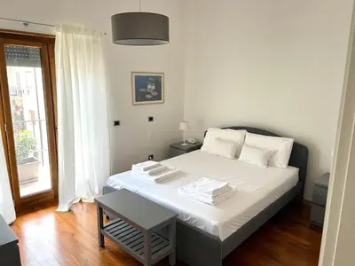 a white bed in a room with a window at SiSo Home in Palermo