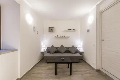 a bedroom with a bed and a table in a room at Vuccirihouse in Palermo