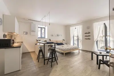 a kitchen and a living room with a table at Vuccirihouse in Palermo