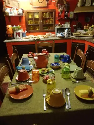 a table with plates and utensils on it in a kitchen at The Garden in Sferracavallo