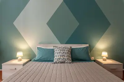 a bedroom with a bed with a blue and green wall at Good Vibes apartment nel centro storico in Palermo